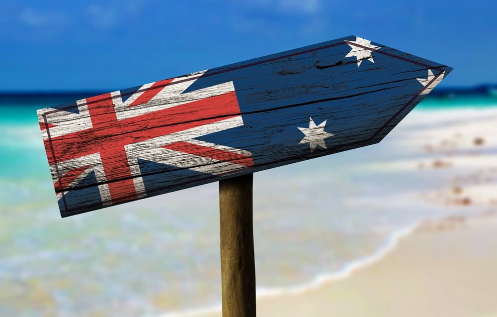Australia flag wooden sign with a beach on background - Oceania-1