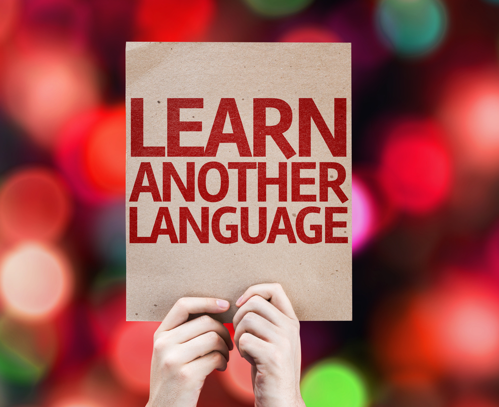 Learn Another Language card with colorful background with defocused lights