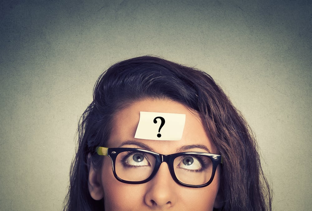 thinking woman with question mark on gray wall background-2